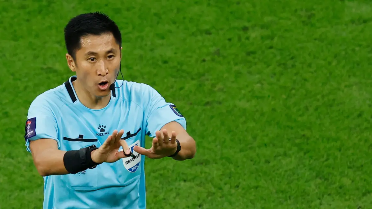 Chinese match referee Ma Ning gestures during the AFC Qatar 2023 Asian Cup final football match between Jordan and Qatar at the Lusail Stadium in Lusail, north of Doha on February 10, 2024. (Photo by KARIM JAAFAR / AFP)