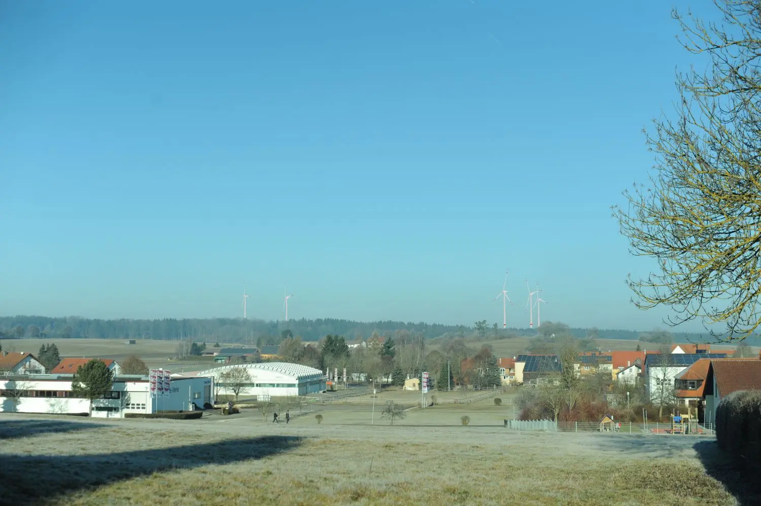 Aus der Ferne werden die Windräder teilweise zu sehen sein, allerdings wird die Sichtbarkeit durch Bewaldung und Hügel begrenzt. Die Fotomontage zeigt den Blick vom Kreuzbergweg in Ödenwaldstetten.