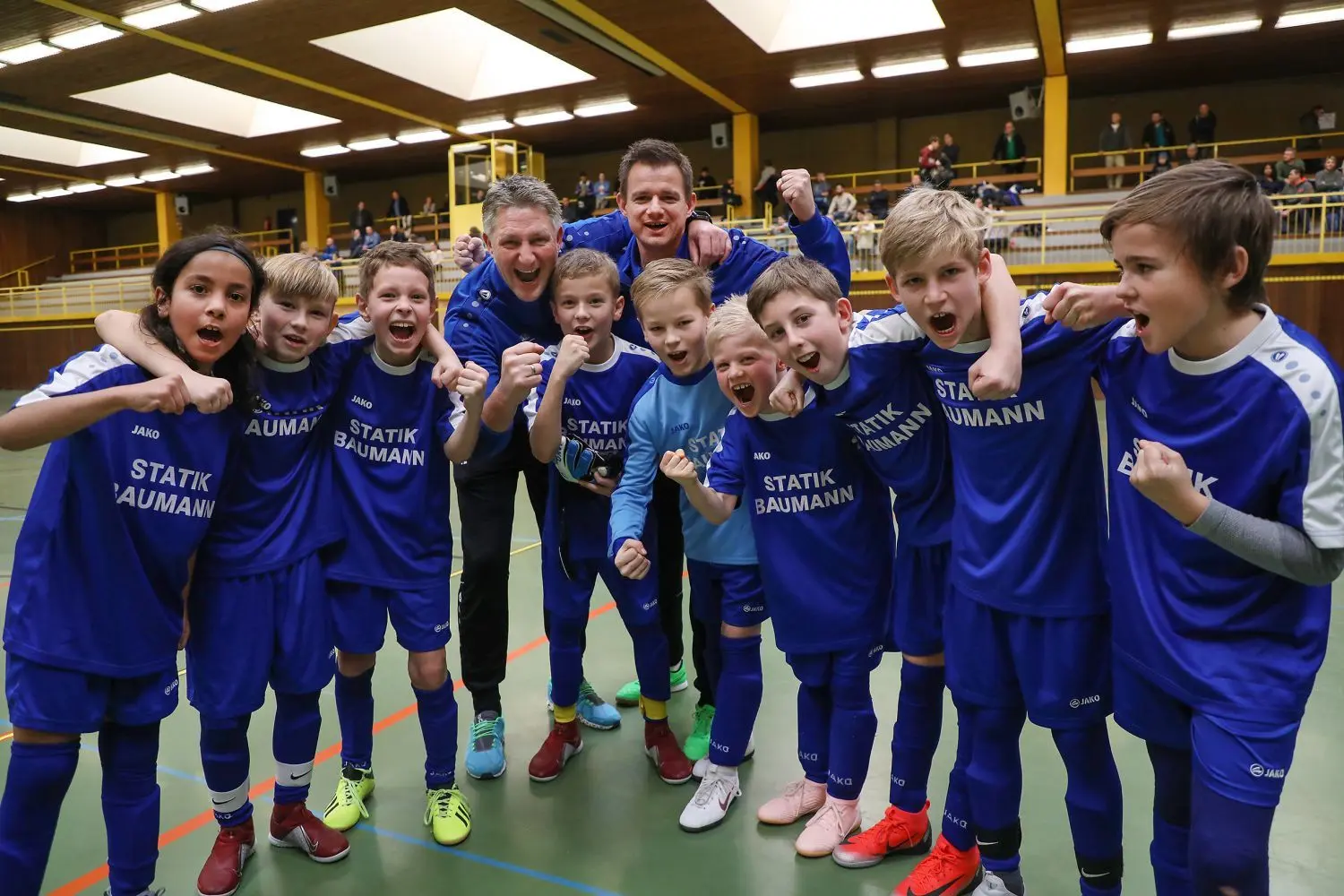 Die E-Junioren der Sportfreunde Schwäbisch Hall ballen die Fäuste nach ihrem Turniersieg bei den Stadtmeisterschaften. Ihre Trainer Niklas Leonberger (hinten, links) und Markus Mürter freuen sich mit ihnen.