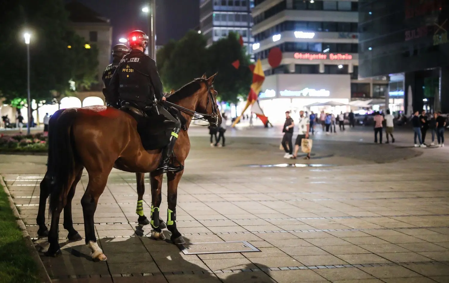 Zwei Polizisten sitzen auf ihren Pferden und beobachten die Lage auf dem Schlossplatz und der Königstraße in Stuttgart.