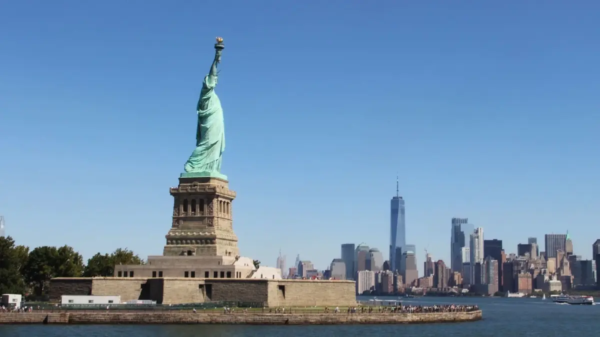 Die Freiheitsstatue reckt im Hafen von New York ihre Fackel in den Himmel.
Freiheitsstatue "Lady Liberty" vor der Skyline von New York (Foto vom 14.09.2022). Aufrecht und selbstbewusst trotzt sie Wind und Wetter und begruesst die Ankoemmlinge aus aller Welt: Rund vier Milllionen Menschen besuchen jedes Jahr die Freiheitsstatue im Hafen von New York. Die rechte Hand mit einer Fackel streckt sie gen Himmel, in der Linken traegt "Lady Liberty" eine Tafel mit der Unabhaengigkeitserklaerung der USA. "JULY IV MDCCLXXVI" steht als Datum darauf: 4. Juli 1776, der Tag, an dem sich 13 Kolonien in Amerika von Grossbritannien losloesten. Mit grossem Pomp wird der 4. Juli jedes Jahr als US-Unabhaengigkeitstag begangen. (Siehe epd-Feature vom 22.06.2023)