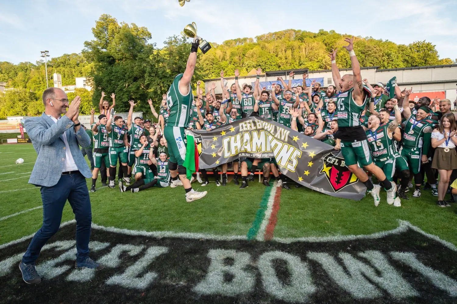 Alessandro Vergani springt mit dem Pokal in Richtung seiner Teamkollegen. Gerade hat er ihn von CEFL-Direktor Gabriel Dielacher (links) überreicht bekommen.⇥