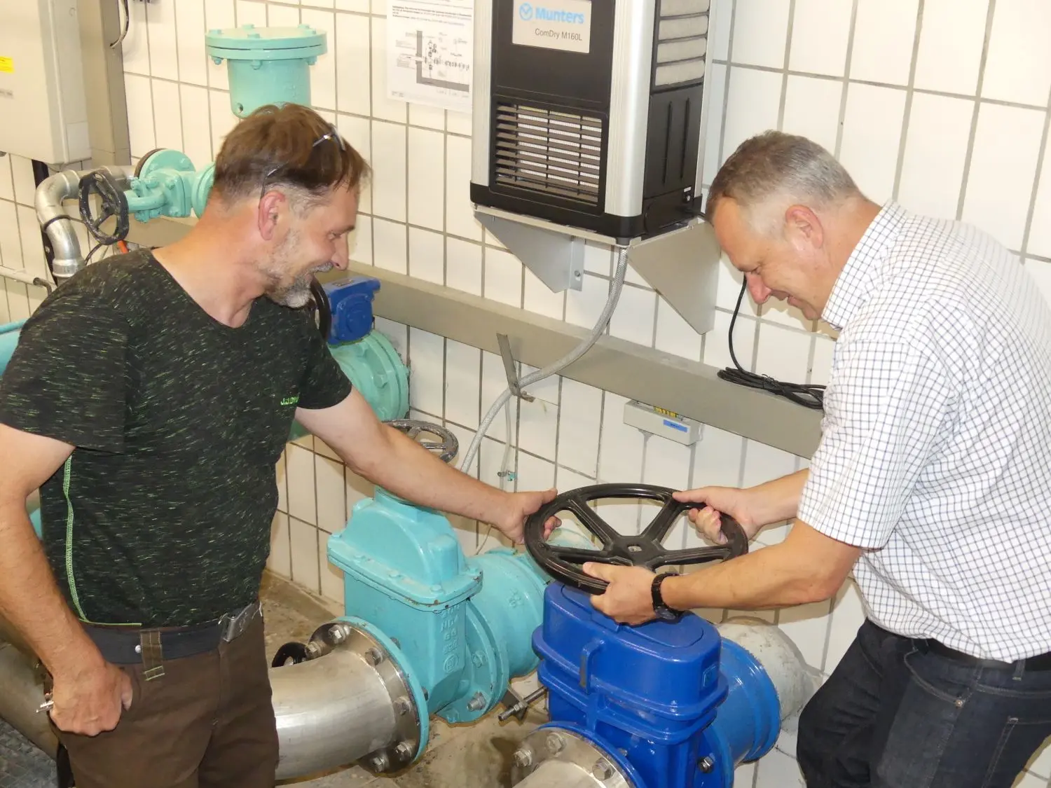Im Hochbehälter Grafenberg drehen Bauhofleiter Andreas Mayer und Bürgermeister Volker Brodbeck symbolisch am Rad der Wasserversorgungsverband Jusigruppe. ⇥