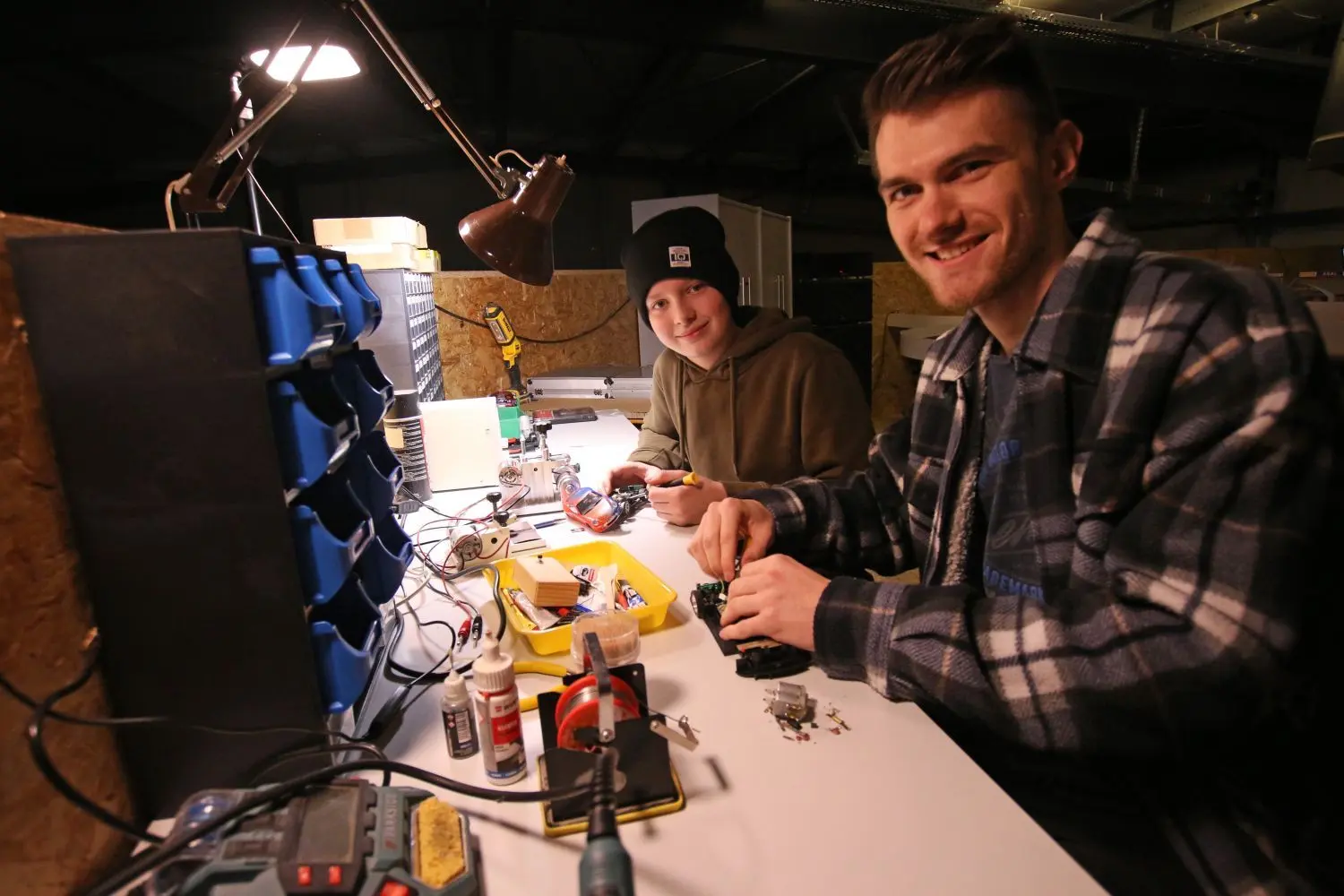 Tim und Malte basteln in der Werkstatt neben der Strecke.