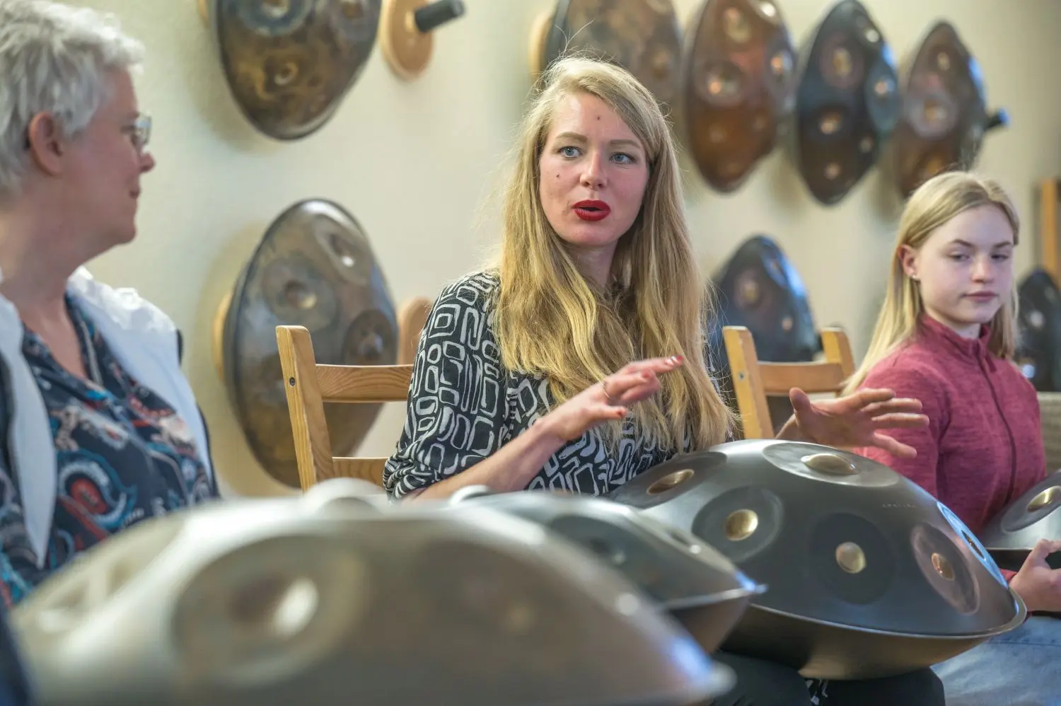 Kate Stone (Mitte) mit zwei Teilnehmerinnen im Handpan-Workshop „Komposition“. Der Spaßfaktor im Kurs ist groß – auch wenn ihr „die liebe Pferdeherde“ mal davongaloppiert.⇥