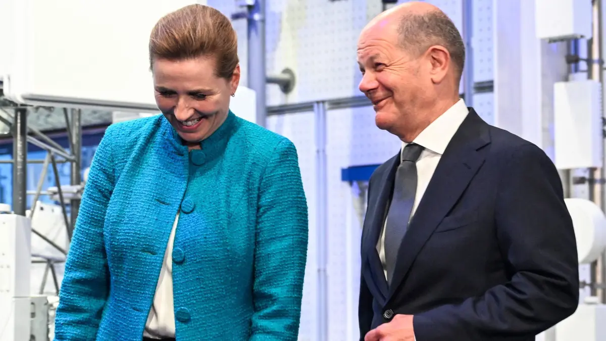 Denmark's Prime Minister Mette Frederiksen (L) and German Chancellor Olaf Scholz chat during a visit to telecom company Ericsson headquearters in Kista, Stockholm, Sweden, on May 13, 2024, during a two-day Nordic Prime Minister's meeting, on security and competitiveness. (Photo by Pontus LUNDAHL / TT NEWS AGENCY / AFP) / Sweden OUT
