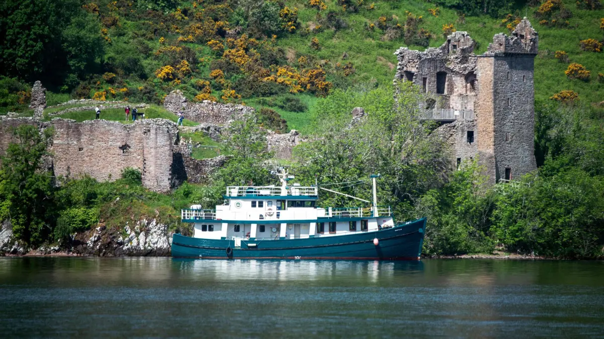 A boat takes part in the search of the Loch Ness Monster in the Scottish Highlands on June 1, 2024 as researchers and enthusiasts from around the world try to track down the elusive Nessie. (Photo by Andy Buchanan / AFP)