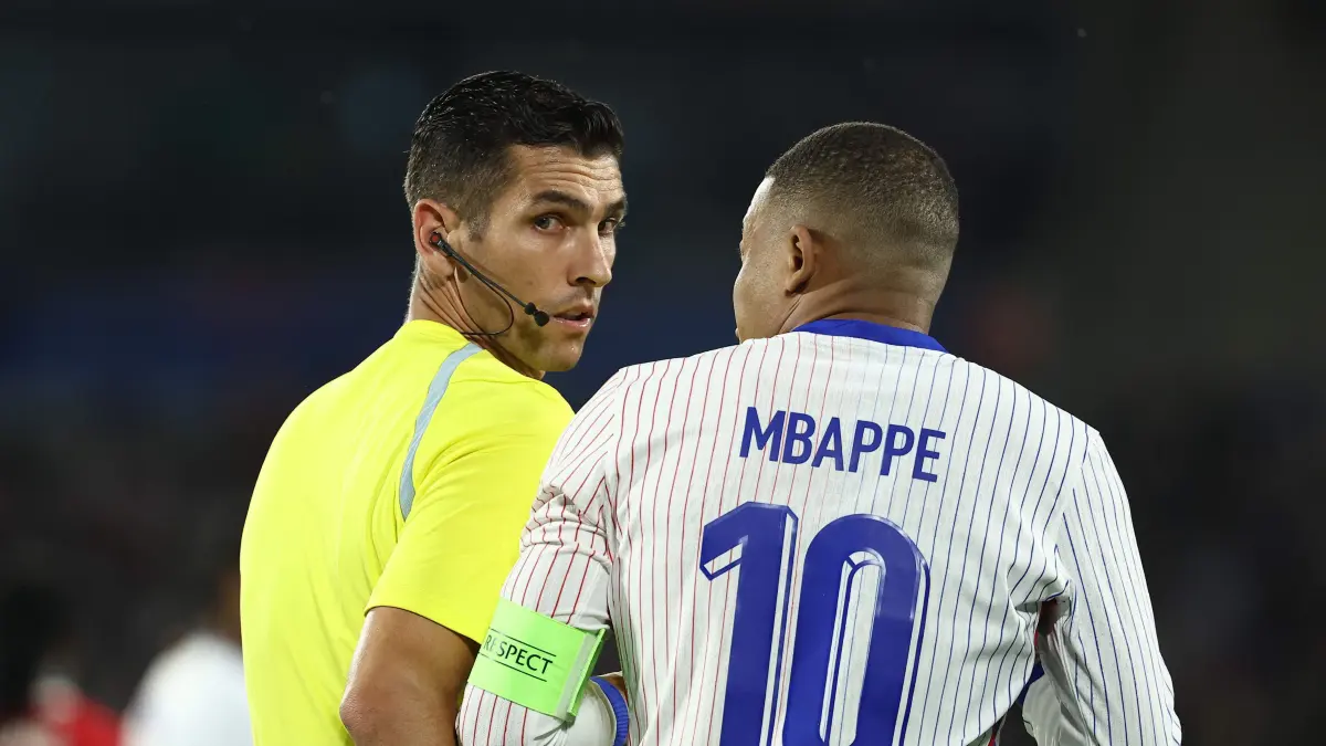 France's forward #10 Kylian Mbappe (R) talks to Portuguese referee Fabio Verissimo (L) during the International friendly football match between France and Canada at the Matmut Atlantique stadium in Bordeaux, on June 9, 2024. (Photo by FRANCK FIFE / AFP)
