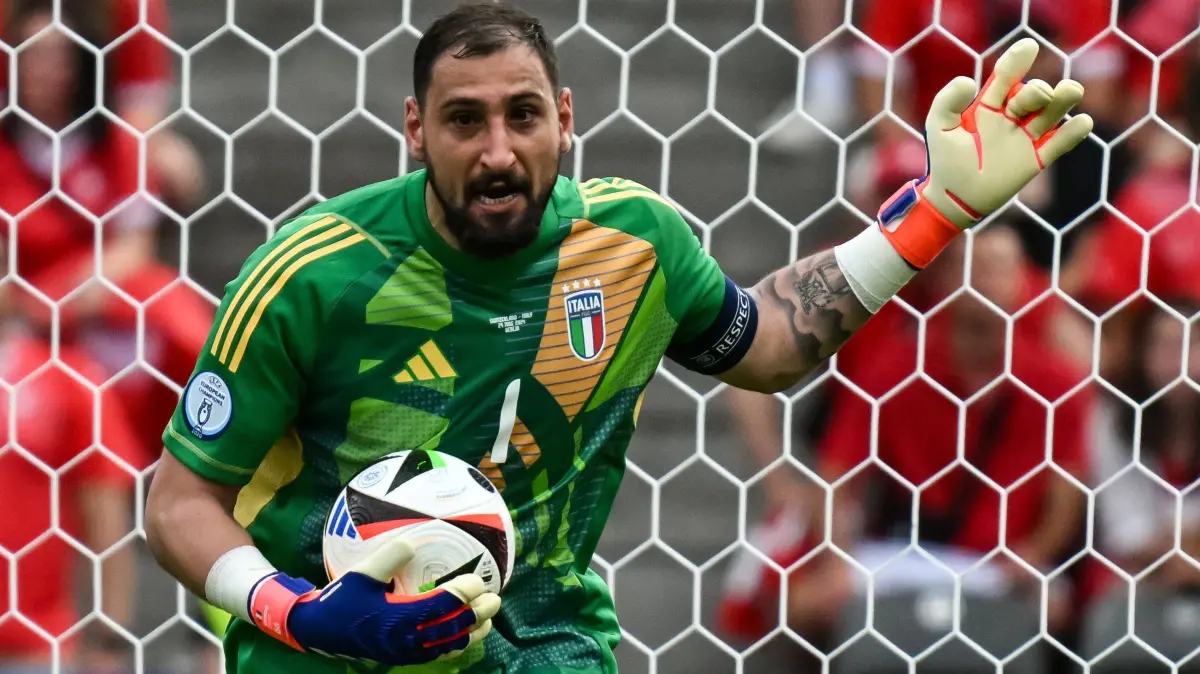 Italy's goalkeeper #01 Gianluigi Donnarumma reacts during the UEFA Euro 2024 round of 16 football match between Switzerland and Italy at the Olympiastadion Berlin in Berlin on June 29, 2024. (Photo by Fabrice COFFRINI / AFP)