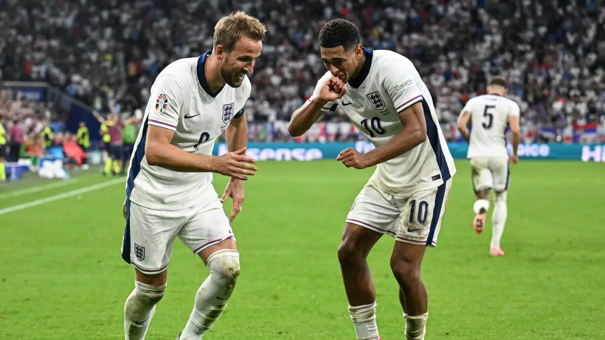 (From L) England's forward #09 Harry Kane and England's midfielder #10 Jude Bellingham celebrate after Kane scored his team's second goal during the UEFA Euro 2024 round of 16 football match between England and Slovakia at the Arena AufSchalke in Gelsenkirchen on June 30, 2024. (Photo by PATRICIA DE MELO MOREIRA / AFP)