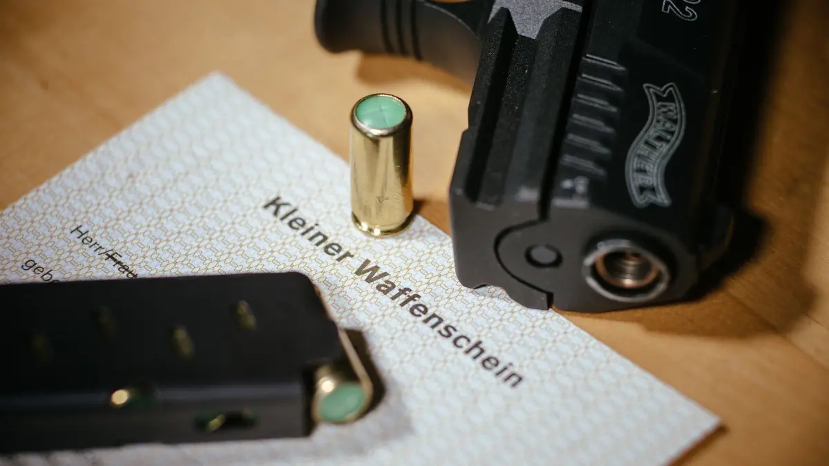 Kleiner Waffenschein: ARCHIV - 26.11.2015, Sachsen, Dresden: ARCHIV - ILLUSTRATION - Ein Kleiner Waffenschein liegt am 27.11.2015 in Dresden (Sachsen) zwischen einer Schreckschuss-Pistole «Walther P22», einem Magazin und einer Knallpatrone. Die AfD in Sachsen-Anhalt fordert eine Liberalisierung des Waffengesetzes. «Völlig abwegig» sagen die Gewerkschaft der Polizei und der Innenminister. Foto\ Oliver Killig/dpa +++(c) dpa - Bildfunk+++ (zu dpa: «Urteile: AfD-Mitglieder müssen Waffen abgeben») Foto: Oliver Killig/dpa +++ dpa-Bildfunk +++