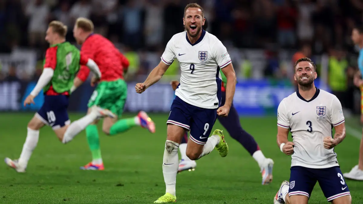 England's forward #09 Harry Kane (L) and England's defender #03 Luke Shaw celebrate after winning the UEFA Euro 2024 semi-final football match between the Netherlands and England at the BVB Stadion in Dortmund on July 10, 2024. (Photo by Adrian DENNIS / AFP)