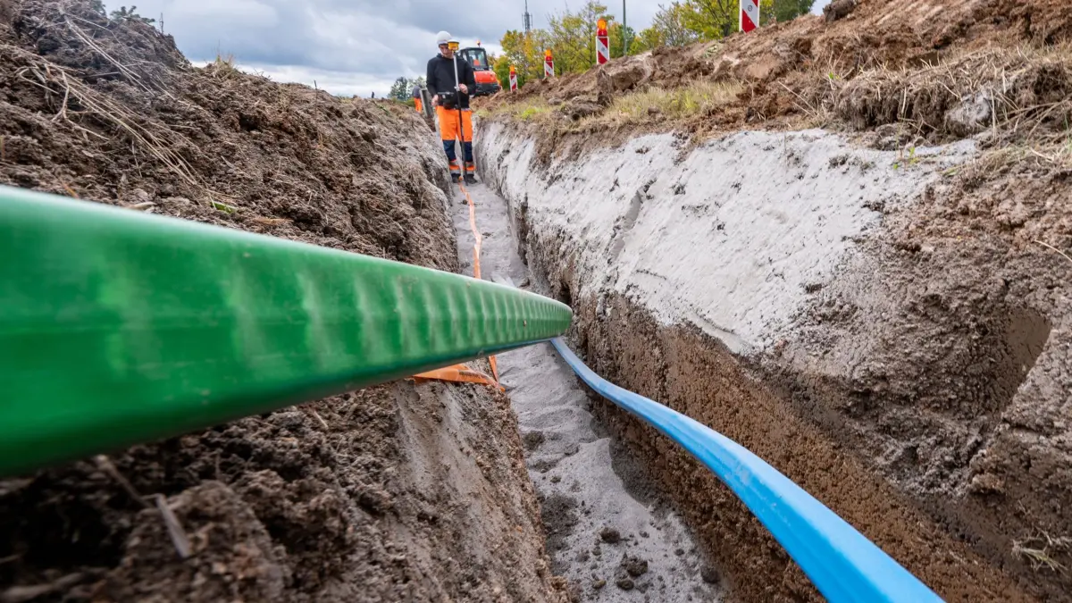 ARCHIV - 12.10.2021, Bayern, Wald: Glasfaserkabel werden in die Erde verlegt. (zu dpa: «Nur ein Viertel der Glasfaser-Mittel bisher ausbezahlt») Foto: Armin Weigel/dpa +++ dpa-Bildfunk +++