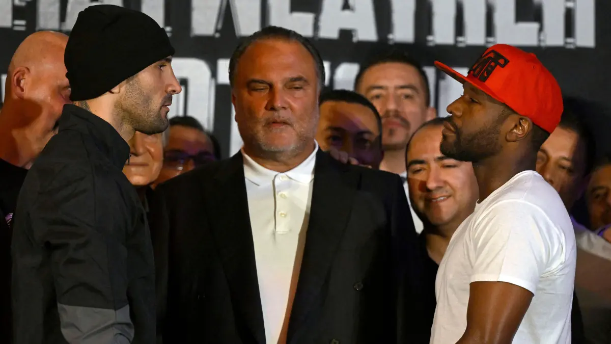 US boxers Floyd Mayweather Jr. (R) and John Gutti III (L) look at each other during the weighing ceremony for his upcoming exhibition in Mexico City on August 23, 2024. Mayweather Jr. and Gotti III will face each other in an exhibition fight in Mexico on August 24, 2024. (Photo by ALFREDO ESTRELLA / AFP)