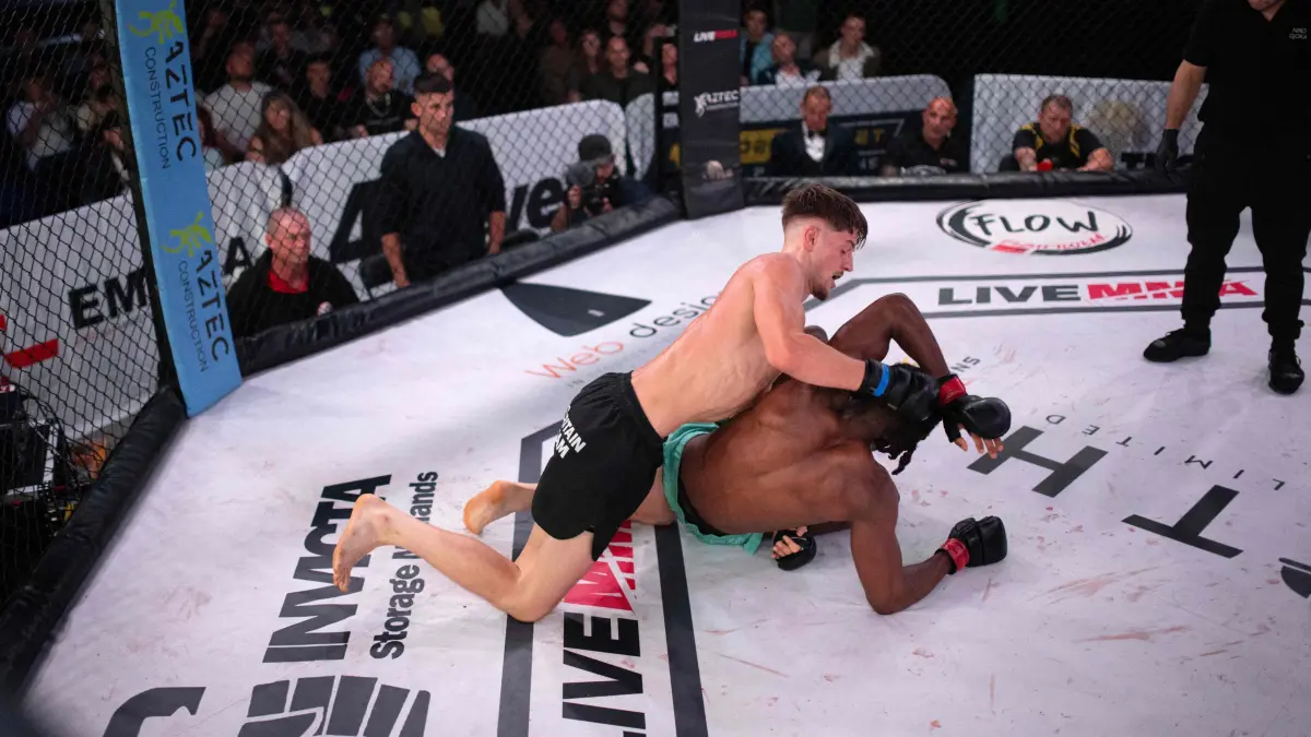 Mixed martial arts fighters Moseke Becke (R) and James Howlett compete in a cage fight during an evening of MMA combat hosted by 'Golden Ticket Fight Promotions' in Wolverhampton, central England, on September 7, 2024. Mixed Martial Arts fighting is a full-contact combat sport based on techniques of striking, throwing, kicking, and grappling with an opponent, often incorporating techniques from various combat sports including: boxing, wrestling, kickboxing and martial arts. Cage fighting events attract an international roster of fighters in both the amateur and professional categories. (Photo by Oli SCARFF / AFP) / RESTRICTED TO EDITORIAL USE