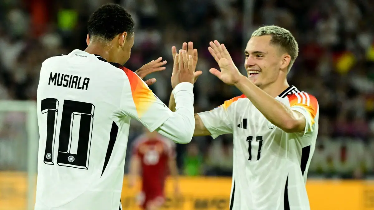 Germany's midfielder #10 Jamal Musiala (L) is congratulated by Germany's midfielder #17 Florian Wirtz after scoring the 2-0 goal during the League A Group A3 football match of the UEFA Nations League between Germany and Hungary in in Duesseldorf, western Germany, on September 7, 2024. (Photo by John MACDOUGALL / AFP)