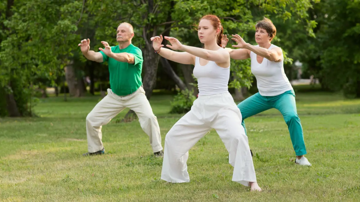A group of people practice Tai Chi Chuan in a park. Chinese management skill, Qi's energy.