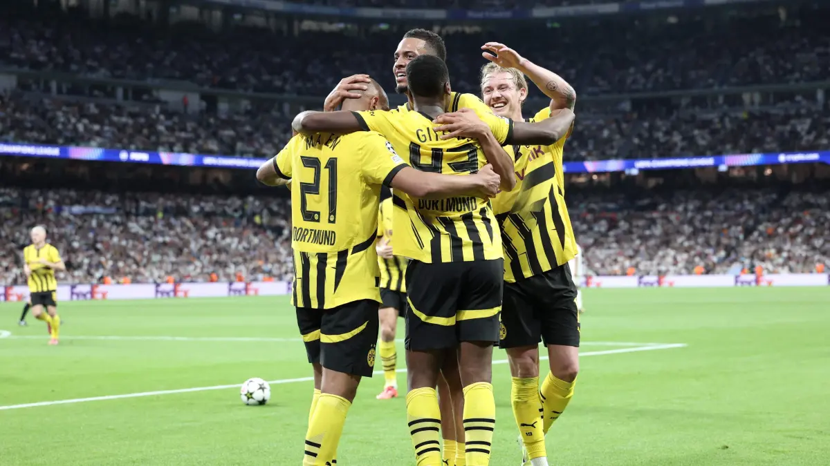 Borussia Dortmund's players celebrate scoring a goal during the UEFA Champions League, league phase day 3 football match between Real Madrid CF and Borussia Dortmund at the Santiago Bernabeu stadium in Madrid on October 22, 2024. (Photo by Thomas COEX / AFP)