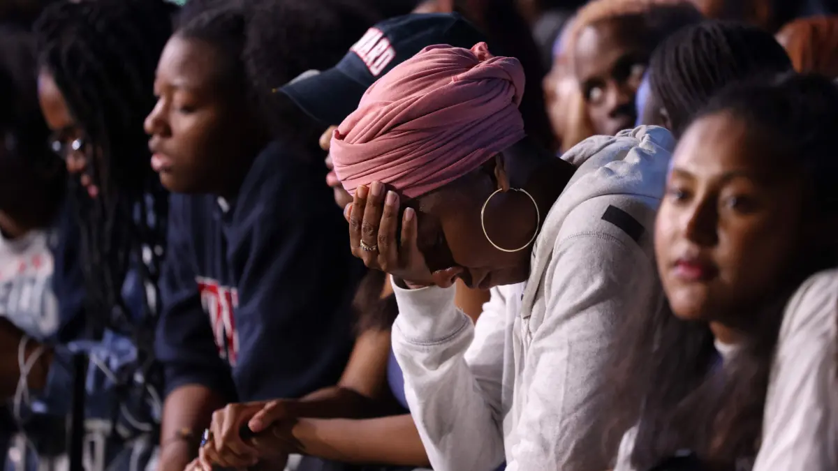 A woman holds her head as supporters of US Vice President and Democratic presidential candidate Kamala Harris attend an election night event at Howard University in Washington, DC, on November 5, 2024. (Photo by CHARLY TRIBALLEAU / AFP)