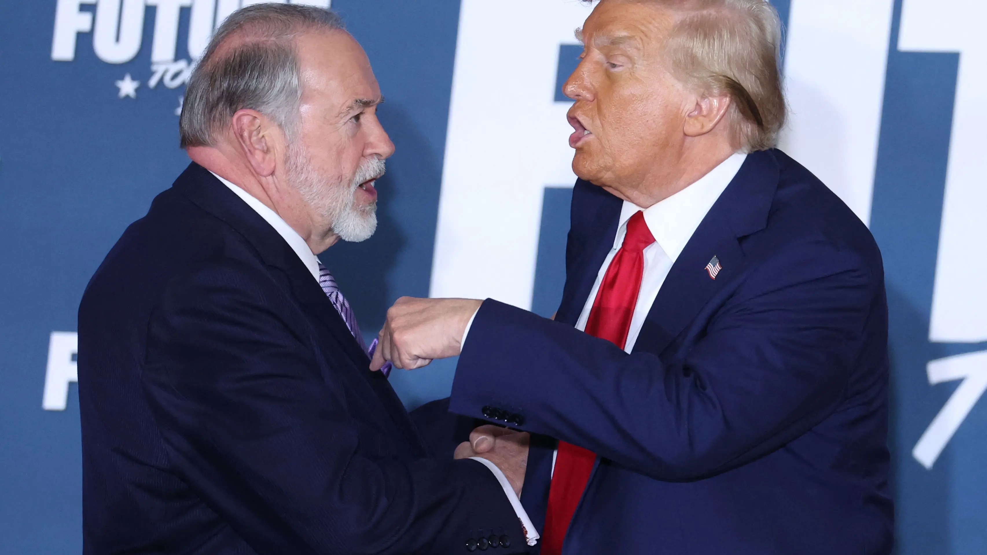 (FILES) Former U.S. President and Republican presidential candidate Donald Trump and Mike Huckabee shake hands after participating in a roundtable discussion hosted by Building America?s Future in Drexel Hill, Pennsylvania, on October 29, 2024. US President-elect Donald Trump announced on November 12, 2024. his intention to nominate former Arkansas governor Mike Huckabee as US ambassador to Israel. (Photo by Charly TRIBALLEAU/AFP)