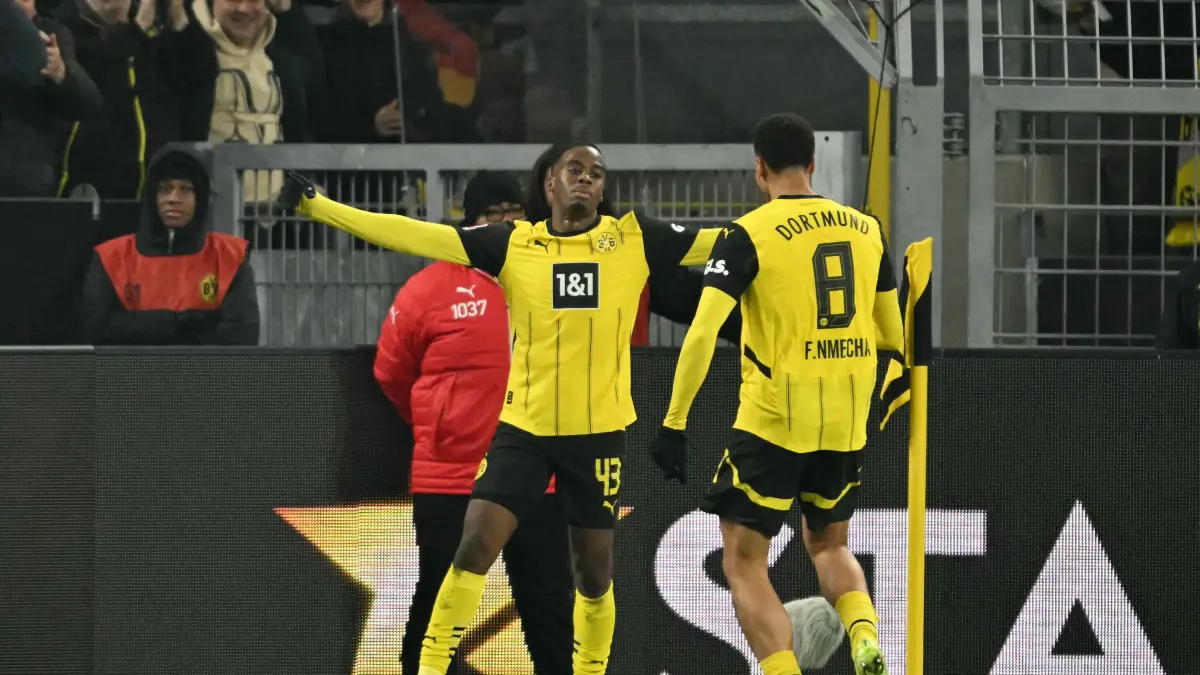 Dortmund's English forward #43 Jamie Bynoe-Gittens (L) celebrates scoring his team's first goal with Dortmund's German midfielder #08 Felix Nmecha during the German first division Bundesliga football match between BVB Borussia Dortmund and FC Bayern Munich in Dortmund, western Germany on November 30, 2024. (Photo by INA FASSBENDER / AFP) / DFL REGULATIONS PROHIBIT ANY USE OF PHOTOGRAPHS AS IMAGE SEQUENCES AND/OR QUASI-VIDEO