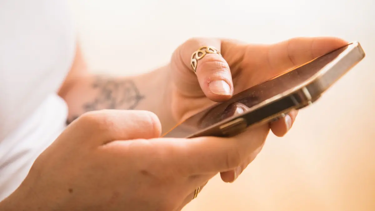 Frau mit Smartphone: ILLUSTRATION - Vorsicht, Phishing: Wer Mails mit angeblich verpassten Telekom-Anrufen erhält, sollte auf keinen Fall auf den Link zur vermeintlichen Sprachnachricht tippen. (zu dpa: ««Telekom»-Mail: Nein, da wartet keine neue Sprachnachricht») Foto: Christin Klose/dpa-tmn - Honorarfrei nur für Bezieher des dpa-Themendienstes +++ dpa-Themendienst +++