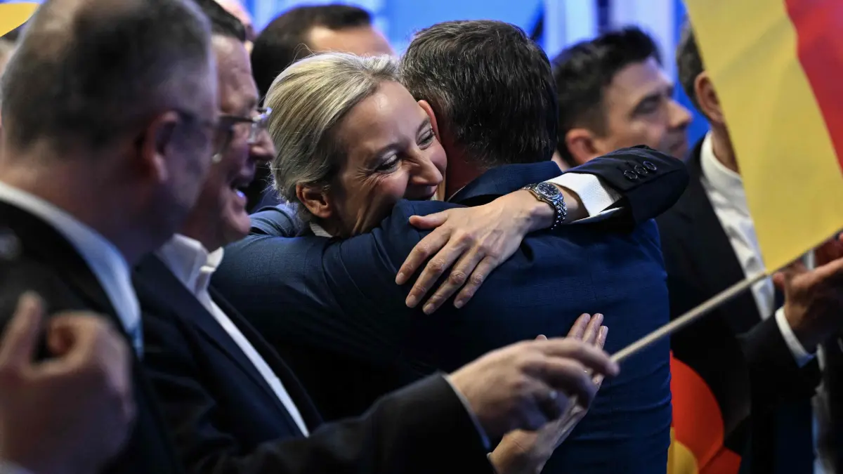 Electoral evening of AfD - Germany's far-right Alternative for Germany (AfD) party: Co-leader of Germany's far-right Alternative for Germany (AfD) party and top candidate for Chancellor Alice Weidel reacts with party members during the electoral evening in Berlin on February 23, 2025, after the first exit polls in the German general elections. (Photo by RALF HIRSCHBERGER / AFP)