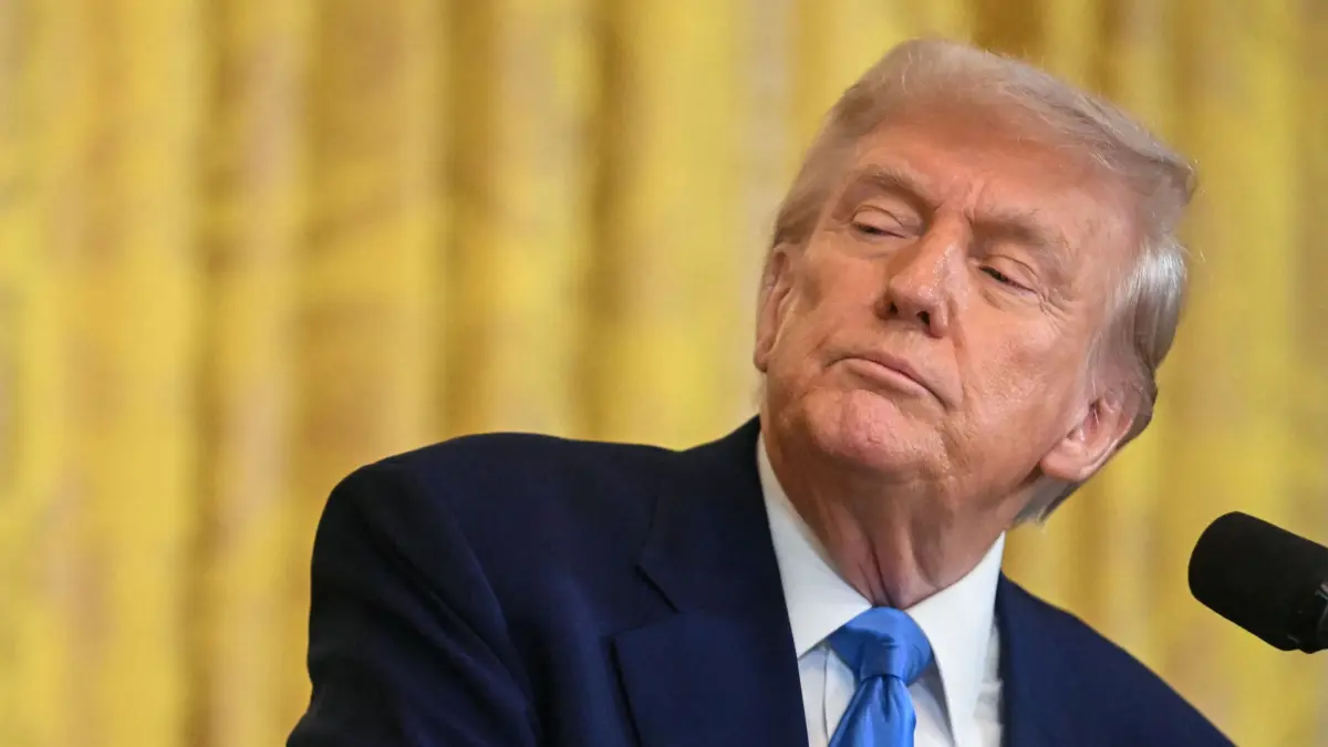 US President Donald Trump looks on as French President Emmanuel Macron speaks during a joint press conference in the East Room to the White House in Washington, DC, on February 24, 2025. (Photo by Jim WATSON / AFP)