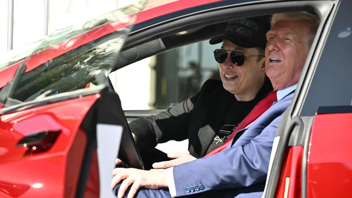 Tesla Q1 results: (FILES) US President Donald Trump and Tesla CEO Elon Musk speak to the press as they sit in a Tesla vehicle on the South Portico of the White House on March 11, 2025 in Washington, DC. Elon Musk will significantly scale back his Trump administration work in May to focus on Tesla, the billionaire announced April 22 as the electric vehicle maker reported a 71 percent drop in first-quarter profits.
"Probably in the next month, my time allocation to DOGE will drop significantly," Musk said at the outset of an earnings conference call, referring to his work for the "Department of Government Efficiency." (Photo by Mandel NGAN / AFP)