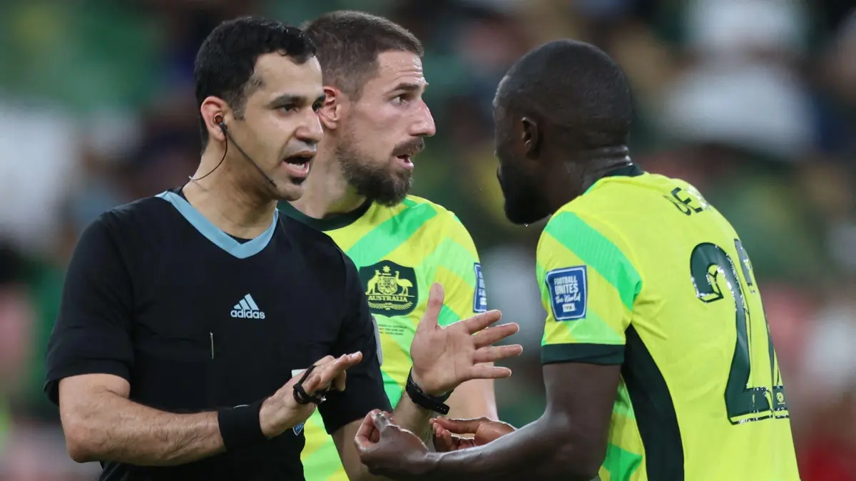 Australia's defender #22 Jason Geria pleads with the Qatari referee Abdulrahman Al-Jassim during the FIFA World Cup 2026 Asia zone qualifiers group C football match between Saudi Arabia and Australia at the King Abdullah Sport City in Jeddah on June 10, 2025. (Photo by Abdel Ghani BASHIR / AFP)