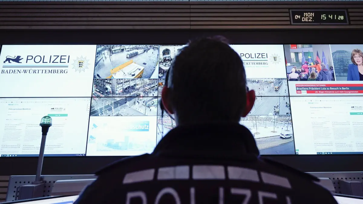 ARCHIV - 04.12.2023, Baden-Württemberg, Mannheim: Ein Beamter steht im Führungs- und Lagezentrum des Polizeipräsidiums Mannheim vor einer Wand mit Bildschirmen. (zu dpa: «Polizei soll umstrittene Palantir-Software nutzen dürfen») Foto: Uwe Anspach/dpa +++ dpa-Bildfunk +++