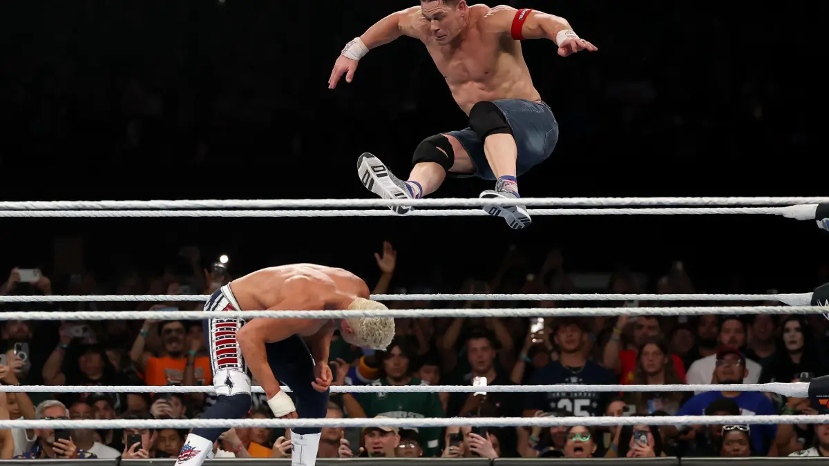 WWE - 2025 SummerSlam: EAST RUTHERFORD, NEW JERSEY - AUGUST 03: John Cena jumps off the top rope and takes down Cody Rhodes during the WWE 2025 SummerSlam at MetLife Stadium on August 03, 2025 in East Rutherford, New Jersey. Elsa/Getty Images/AFP (Photo by ELSA / GETTY IMAGES NORTH AMERICA / Getty Images via AFP)