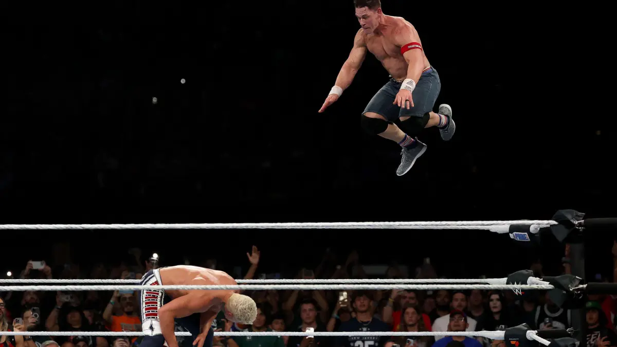WWE - 2025 SummerSlam: EAST RUTHERFORD, NEW JERSEY - AUGUST 03: John Cena jumps off the top rope and takes down Cody Rhodes during the WWE 2025 SummerSlam at MetLife Stadium on August 03, 2025 in East Rutherford, New Jersey. Elsa/Getty Images/AFP (Photo by ELSA / GETTY IMAGES NORTH AMERICA / Getty Images via AFP)