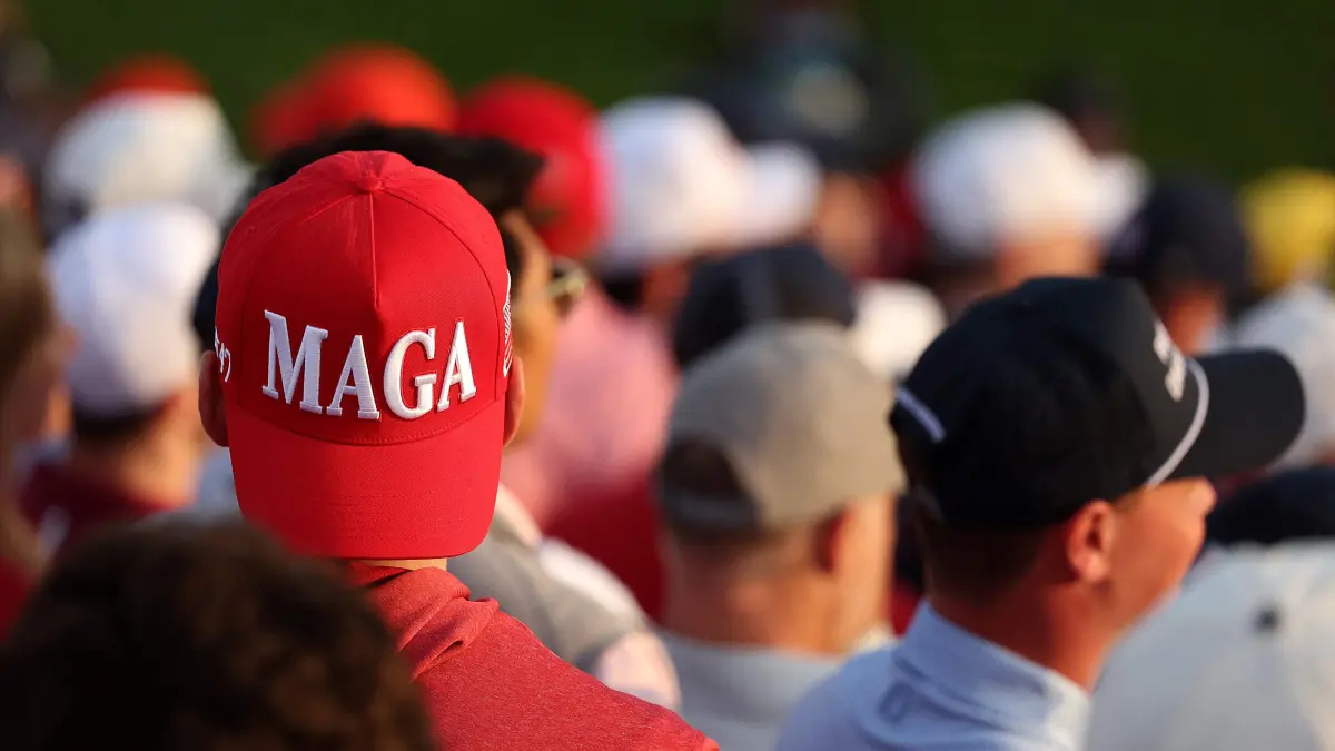 Ryder Cup 2025 - Saturday Morning Foursomes: FARMINGDALE, NEW YORK - SEPTEMBER 27: A spectator in the first grandstand wears a 'MAGA' hat during the Saturday morning foursomes matches of the 2025 Ryder Cup at Black Course at Bethpage State Park Golf Course on September 27, 2025 in Farmingdale, New York. Kate McShane/Getty Images/AFP (Photo by Kate McShane / GETTY IMAGES NORTH AMERICA / Getty Images via AFP)