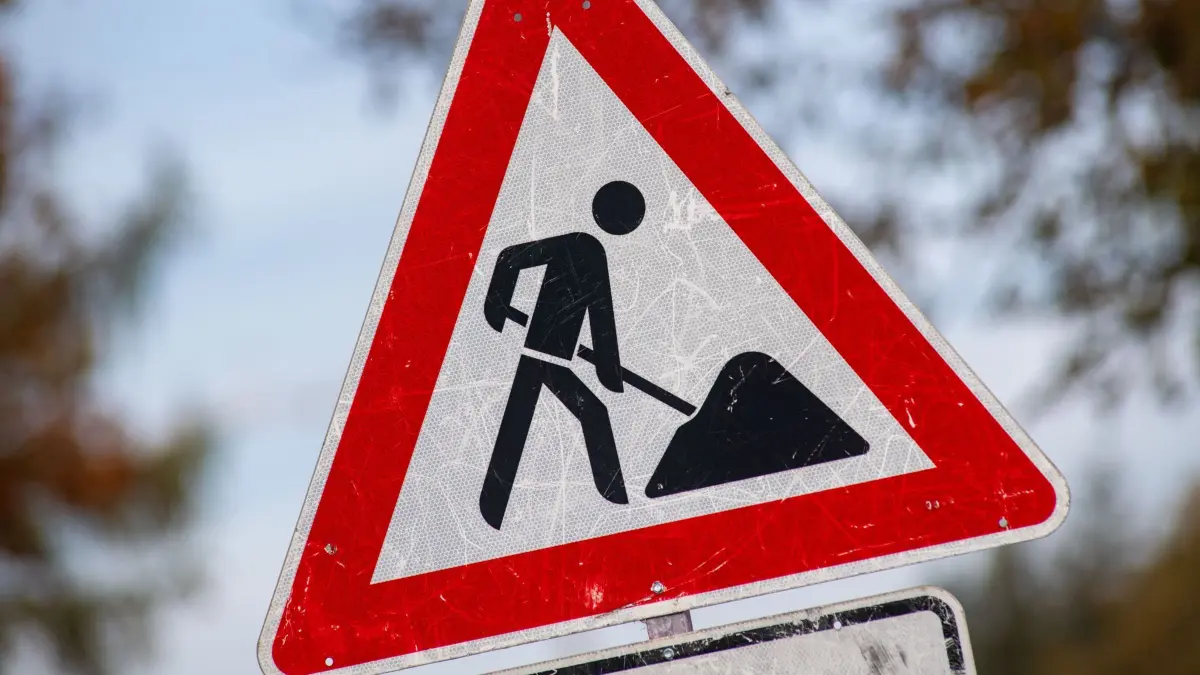 Ein zerkratztes Schild Gefahrzeichen Arbeitsstelle (Zeichen 123) mit dem Piktogramm eines Bauarbeiters zur Beschilderung einer Baustelle. (zu dpa: «B10 zwischen Geislingen und Amstetten wird gesperrt») +++ dpa-Bildfunk +++