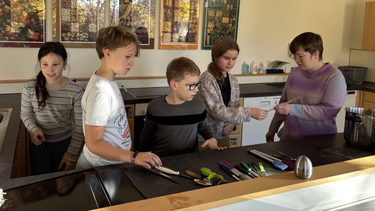 Katharina Bohler (rechts) zeigt den Viertklässlern der Grundschule Untermünkheim, wo in der Lehrküche welches Utensil hinkommt.