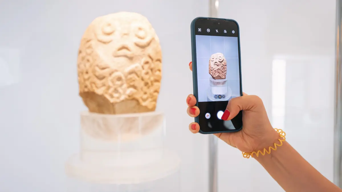 09 June 2024, Boljetin, Serbia: Using a smartphone app to explore virtual artifacts and displays at the Lepenski Vir archaeological site