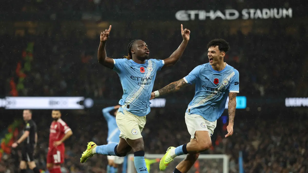 Manchester City's Belgian midfielder #11 Jeremy Doku (L) celebrates scoring their third goal for 3-0 with Manchester City's English midfielder #33 Nico O'Reilly (R) during the English Premier League football match between Manchester City and Liverpool at the Etihad Stadium in Manchester, north west England, on November 9, 2025. (Photo by Darren Staples / AFP) / RESTRICTED TO EDITORIAL USE. No use with unauthorized audio, video, data, fixture lists, club/league logos or 'live' services. Online in-match use limited to 120 images. An additional 40 images may be used in extra time. No video emulation. Social media in-match use limited to 120 images. An additional 40 images may be used in extra time. No use in betting publications, games or single club/league/player publications. /