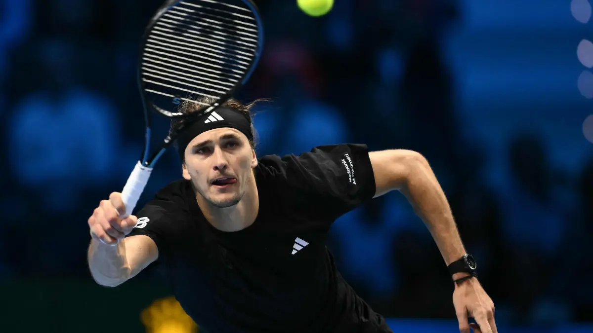 Germany's Alexander Zverev runs to return the ball to Italy's Jannik Sinner at the ATP Finals tennis tournament in Turin on November 12, 2025. (Photo by Marco BERTORELLO / AFP)