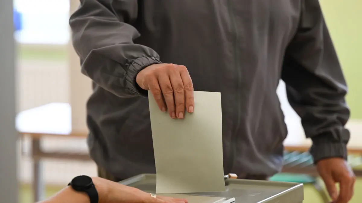 ARCHIV - 10.07.2022, Sachsen, Dresden: Ein Mann wirft beim zweiten Wahlgang zur Oberbürgermeisterwahl im Wahllokal in einer Grundschule seinen Stimmzettel in eine Wahlurne. (zu dpa: «Oft nur wenige Kandidaten bei Bürgermeisterwahlen im Land») Foto: Robert Michael/dpa +++ dpa-Bildfunk +++