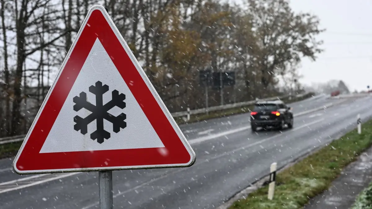 Winter in Niedersachsen: 21.11.2025, Niedersachsen, Leer: Ein Verkehrszeichen an einer Straße weist auf mögliche Glätte auf der Fahrbahn hin. Auch im Nordwesten Deutschlands herrscht winterliches Wetter. Foto: Lars Penning/dpa +++ dpa-Bildfunk +++