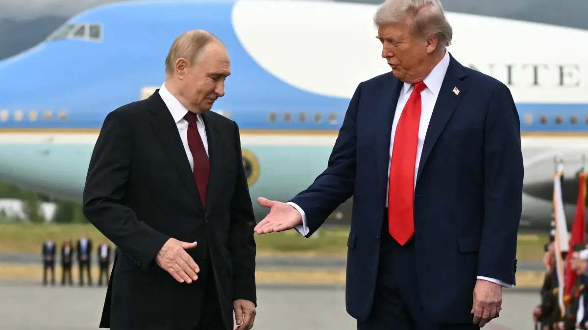 AFP PICTURES OF THE YEAR 2025
US President Donald Trump (R) reaches out to shake hands with Russian President Vladimir Putin as they pose on a podium on the tarmac after arrival at Joint Base Elmendorf-Richardson in Anchorage, Alaska, on August 15, 2025.. Putin is in Alaska at the invitation of Trump in his first visit to a Western country since he ordered the 2022 invasion of Ukraine that has killed tens of thousands of people. (Photo by ANDREW CABALLERO-REYNOLDS / AFP) / AFP PICTURES OF THE YEAR 2025