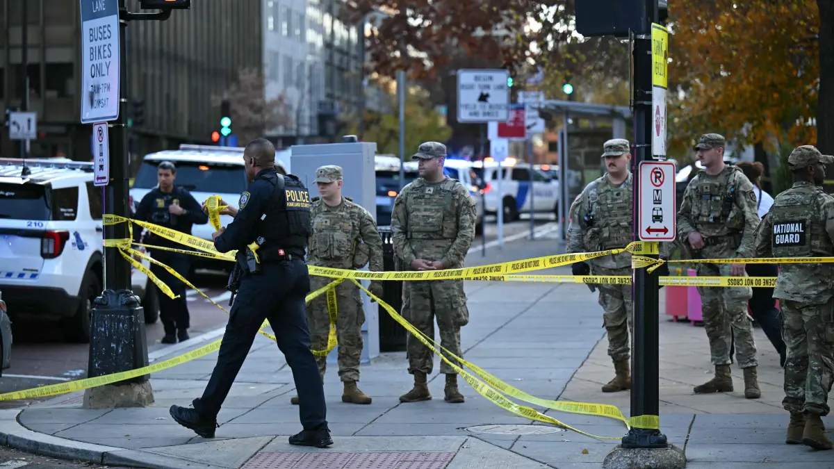 National Guard soldiers gather near a crime scene after a shooting in downtown Washington, DC, on November 26, 2025. Two members of the National Guard were shot Wednesday just blocks from the White House, according to officials, as a spokesperson for Donald Trump said the president has been briefed on the "tragic situation." Police said they had detained a suspect. (Photo by Drew ANGERER / AFP)
