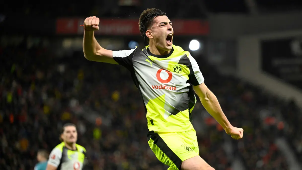 Dortmund's Argentinian defender #28 Aaron Anselmino celebrates his 0-1 during the German first division Bundesliga football match between Bayer 04 Leverkusen and Borussia Dortmund in Leverkusen, western Germany, on November 29, 2025. (Photo by INA FASSBENDER / AFP) / DFL REGULATIONS PROHIBIT ANY USE OF PHOTOGRAPHS AS IMAGE SEQUENCES AND/OR QUASI-VIDEO