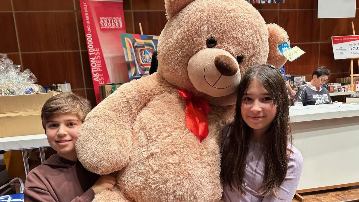 Yunus und Jade mit Teddybär bei der Versteigerung.