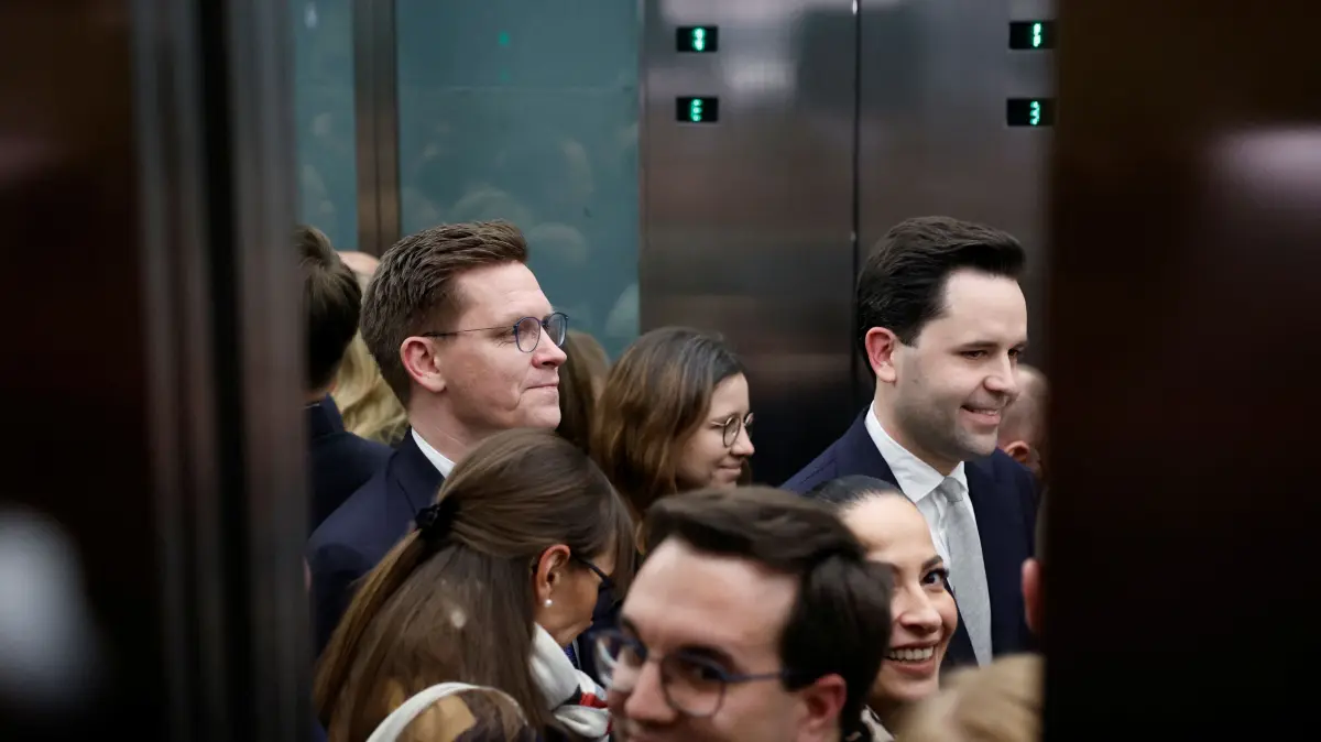 Johannes Winkel (R), leader of the youth organisation "Junge Union" (young union, JU) of Germany's Christian Democratic Union (CDU) party, and
Spokesperson & Chairman of the Working Group Agriculture, Food and Homeland Johannes Steiniger (L) and other deputies are seen leaving in an elevator after a parliamentary group meeting of the conservative CDU/CSU party union at the Reichstag building, seat of the German lower house of parliament Bundestag, in Berlin on December 2, 2025. (Photo by Odd ANDERSEN / AFP)