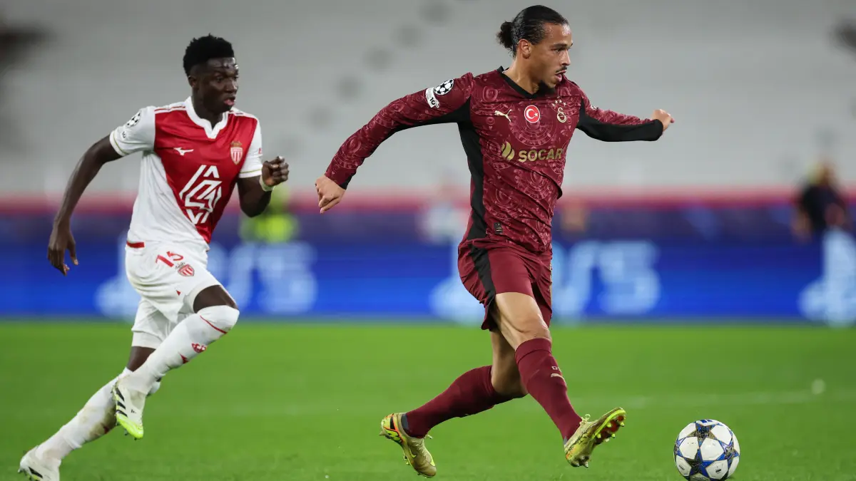 Galatasaray's German midfielder #10 Leroy Sane (R) controls the ball past Monaco's Senegalese midfielder #15 Lamine Camara during the UEFA Champions League, league phase, football match between Monaco and Galatasaray, at the Stade Louis II stadium, in Monaco, on December 9, 2025. (Photo by Valery HACHE / AFP)