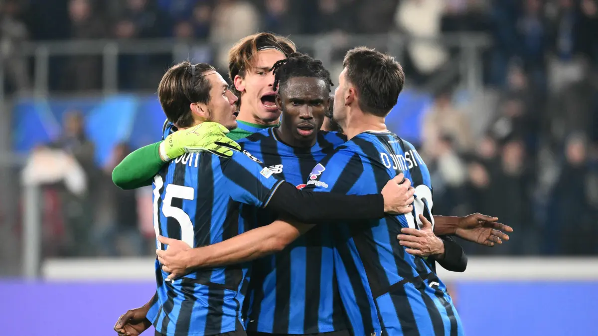 Atalanta's Ivorian defender #03 Odilon Kossounou celebrates with teammates after winning the UEFA Champions League league phase day 6 football match between Atalanta Bergamo and Chelsea FC at Bergamo Stadium, in Bergamo, on December 9, 2025. (Photo by Alberto PIZZOLI / AFP)