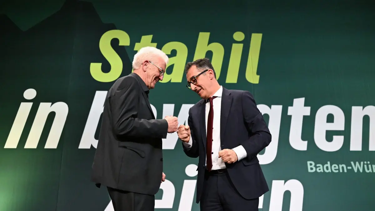 Landesparteitag Bündnis 90/Die Grünen Baden-Württemberg: 12.12.2025, Baden-Württemberg, Ludwigsburg: Winfried Kretschmann (l, Bündnis 90/Die Grünen), Ministerpräsident von Baden-Württemberg, und Cem Özdemir, (r, Bündnis 90 / Die Grünen), Spitzenkandidat für die Landtagswahl in Baden-Württemberg 2026, stehen beim Landesparteitag von Bündnis 90 / Die Grünen Baden-Württemberg nach der Rede von Winfried Kretschmann gemeinsam auf der Bühne. Die Partei beschließt das Wahlprogramm für die Landtagswahl 2026 und wählt neben anderen Parteigremien auch ihren Landesvorstand. Foto: Bernd Weißbrod/dpa +++ dpa-Bildfunk +++