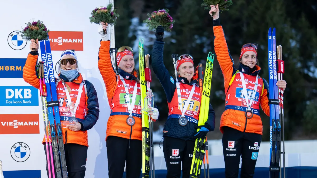 Third placed (L-R) Germany's Anna Weidel, Germany's Julia Tannheimer, Germany's Janina Hettich and Germany's Vanessa Voigt celebrate on the podium after winning the women's 4x6km relay event of the IBU Biathlon World Cup in Hochfilzen, Austria on December 13, 2025. (Photo by GEORG HOCHMUTH / APA / AFP) / Austria OUT